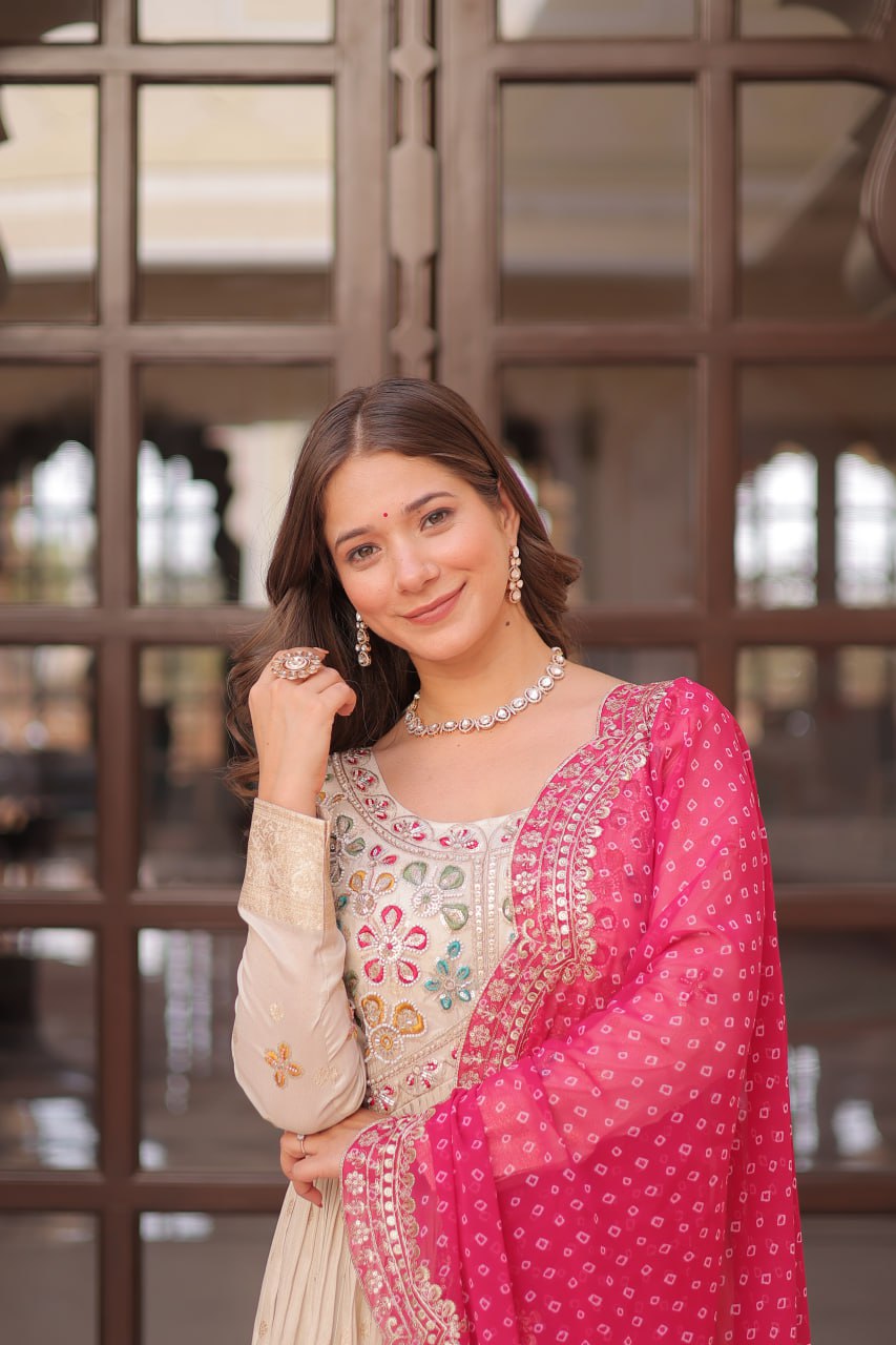 COSMOS WEAVING JAQUARD TRADITIONAL LOOK GOWN WITH BEAUTIFUL BANDHNI PRINT DUPATTA CREAMY COLOR