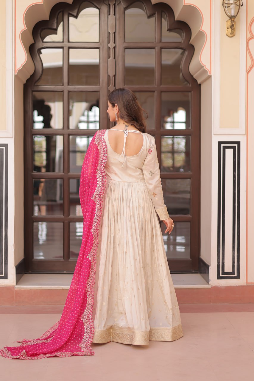 COSMOS WEAVING JAQUARD TRADITIONAL LOOK GOWN WITH BEAUTIFUL BANDHNI PRINT DUPATTA CREAMY COLOR