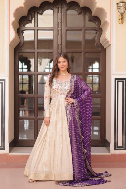 COSMOS WEAVING JAQUARD TRADITIONAL LOOK GOWN WITH BEAUTIFUL BANDHNI PRINT DUPATTA CREAMY COLOR